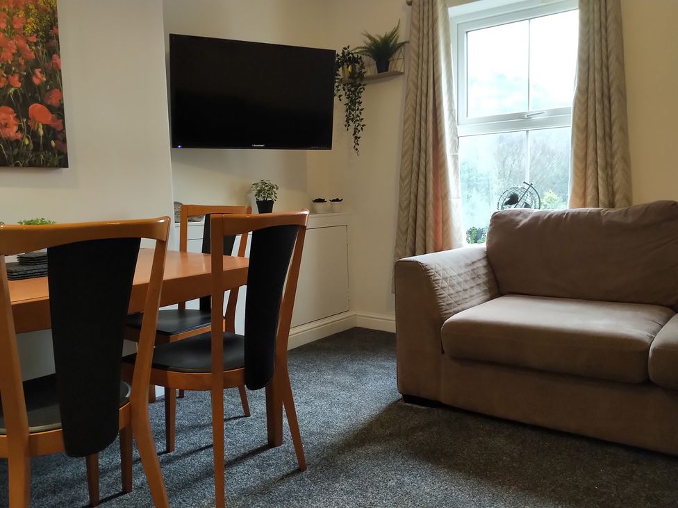 A living room with a dining table and chairs at Oliver Wests Apartment 4 in Scarborough