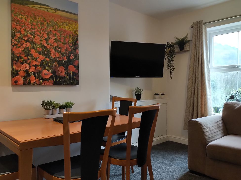 A living room with a dining table and chairs at Oliver Wests Apartment 4 in Scarborough