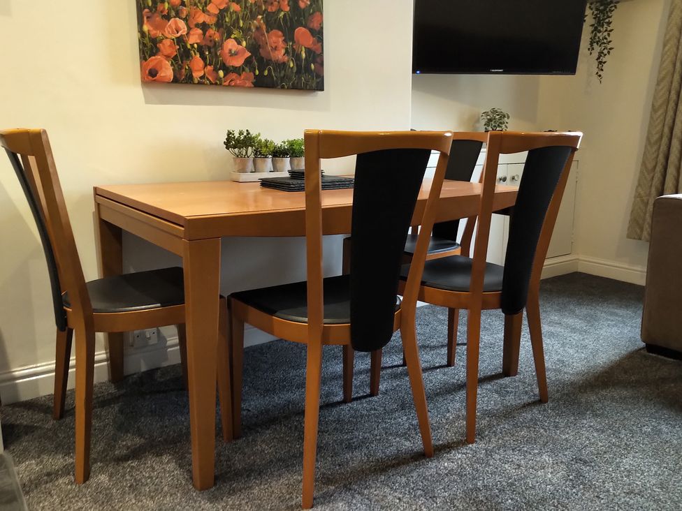 A dining table and chairs at Oliver Wests Apartment 4 in Scarborough