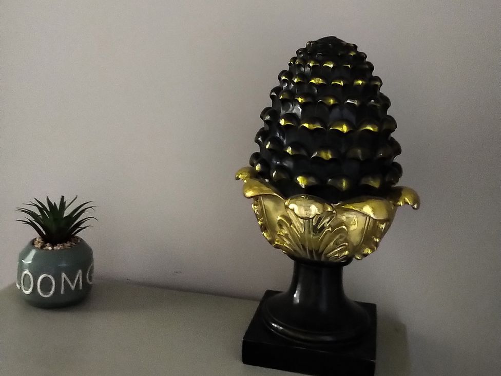 A decorative object resembling a pinecone on a table at Oliver Wests Apartment 4 Scarborough