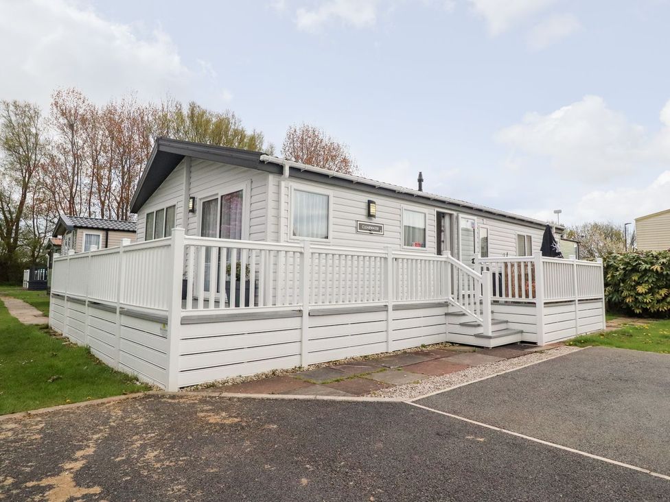 A house with a deck and steps at Rosella 38 Morecambe