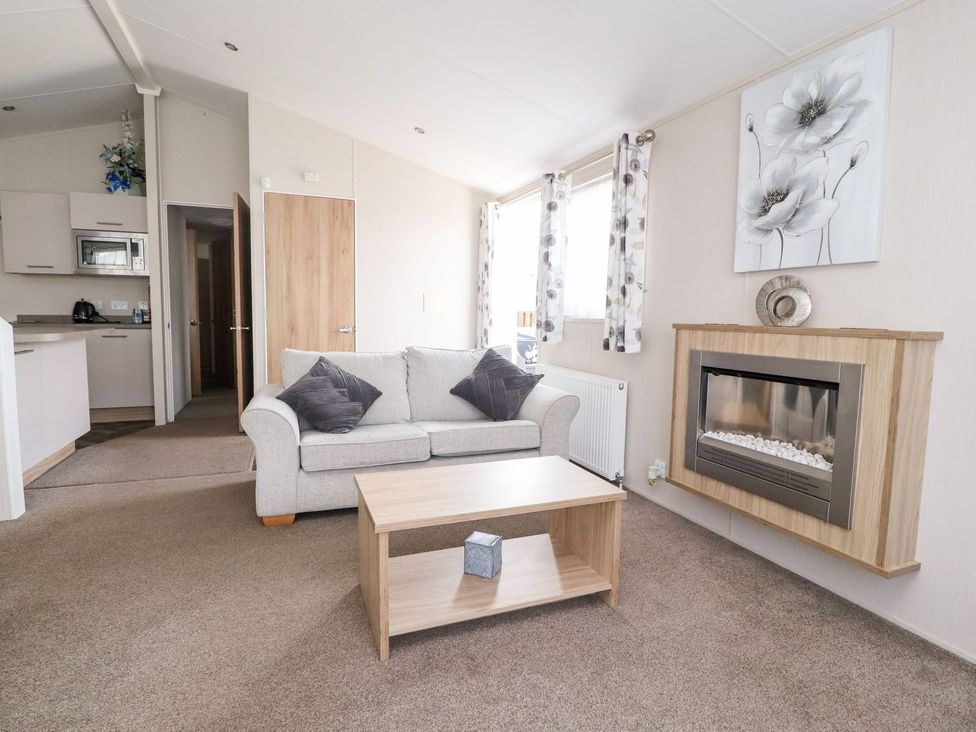 A living room with a sofa and coffee table at Rosella 38 in Morecambe