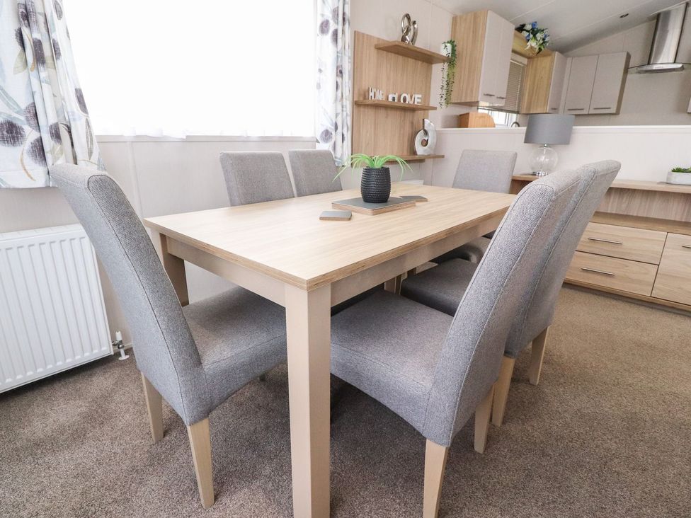 A dining room with a table and chairs at Rosella 38 Morecambe