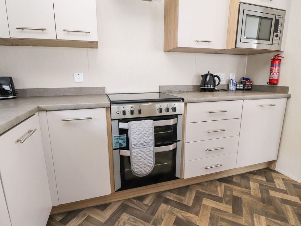 A kitchen with an oven and microwave at Rosella 38 Morecambe