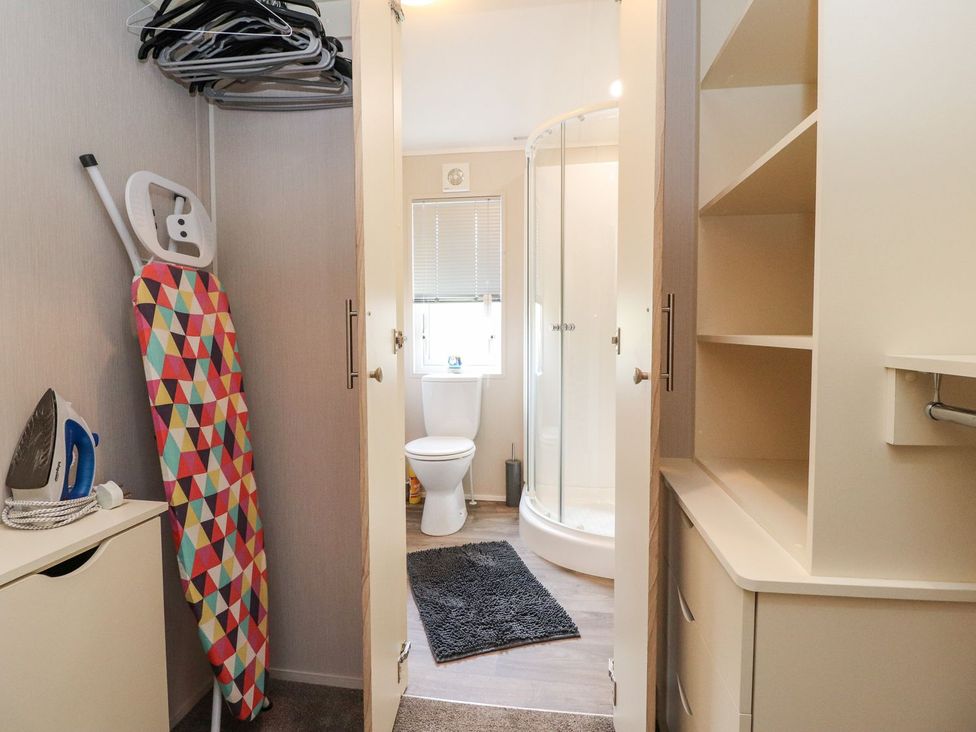 A bathroom with an iron and ironing board at Rosella 38 in Morecambe