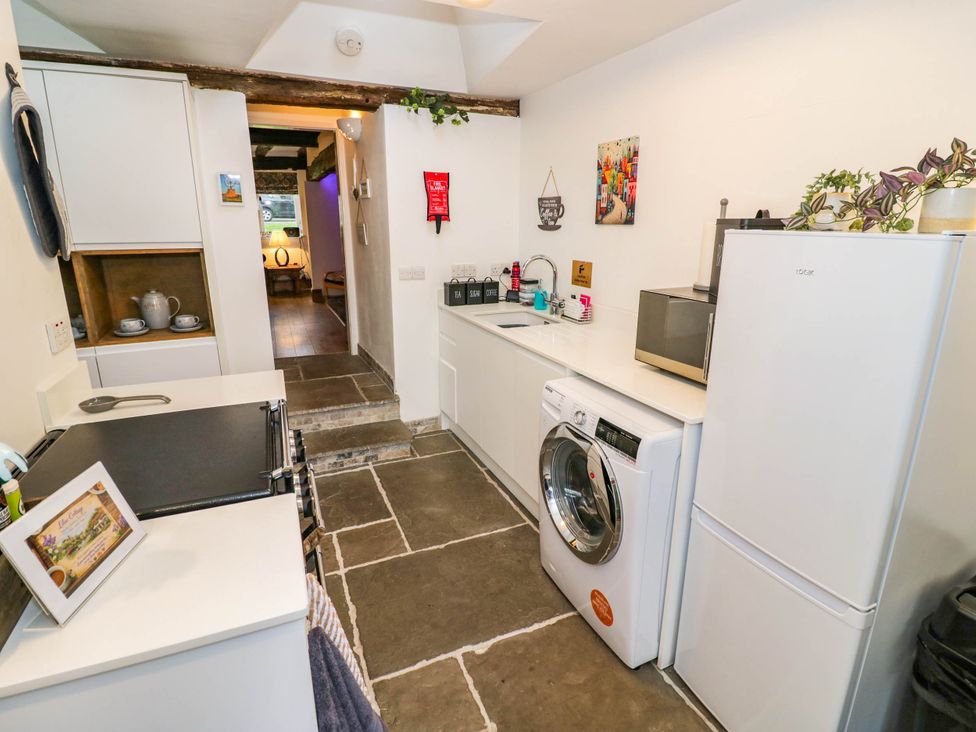 A kitchen with appliances and utensils at Lilac Cottage in Brinklow