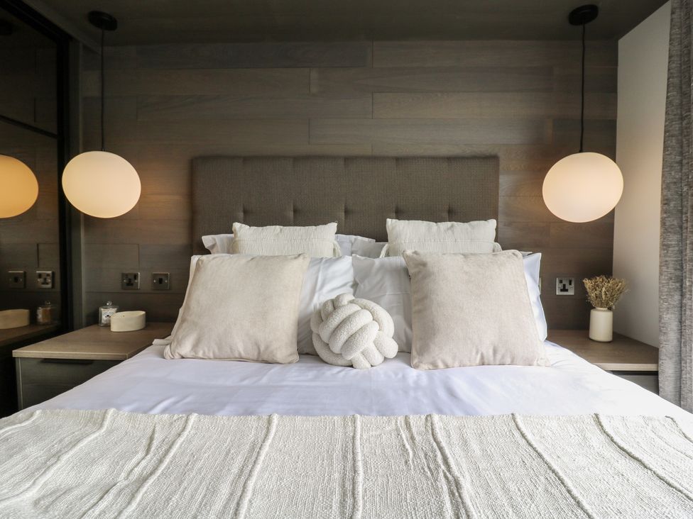 A bedroom with a bed and pillows at Lodge 2 in St. Osyth
