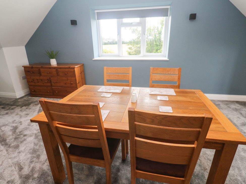 A dining room with a table and chairs at 6 Coswinsawsin Lane near Camborne