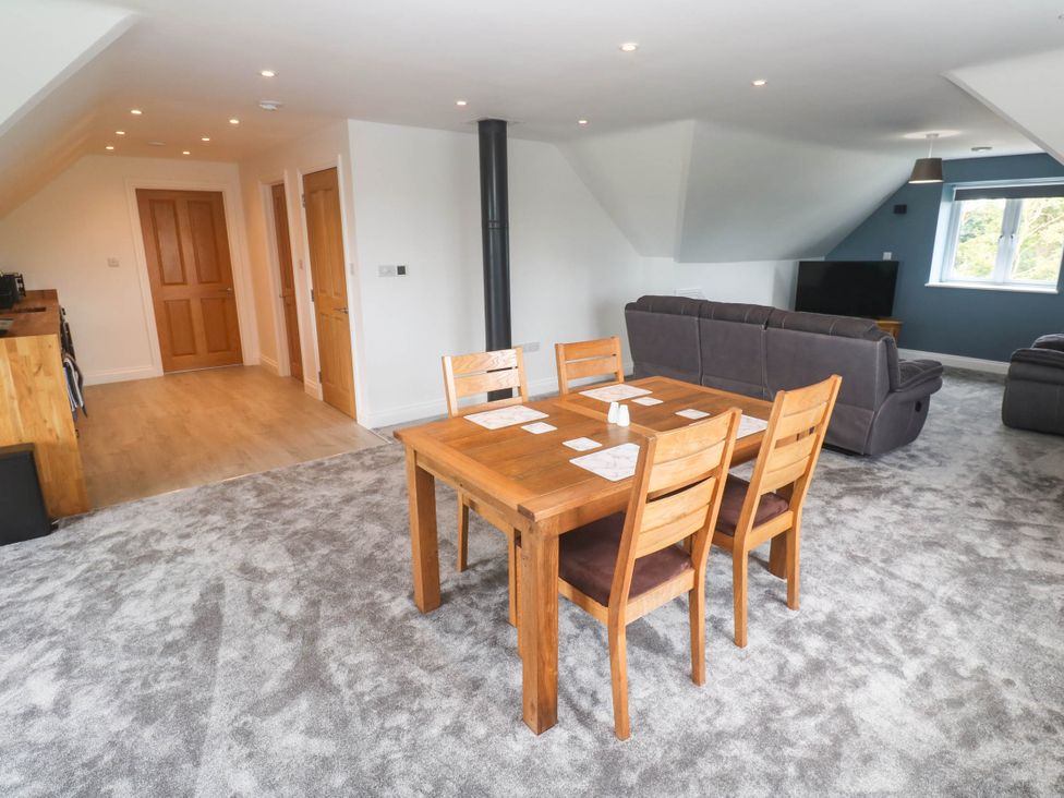 A living room with a dining table and sofa at 6 Coswinsawsin Lane near Camborne