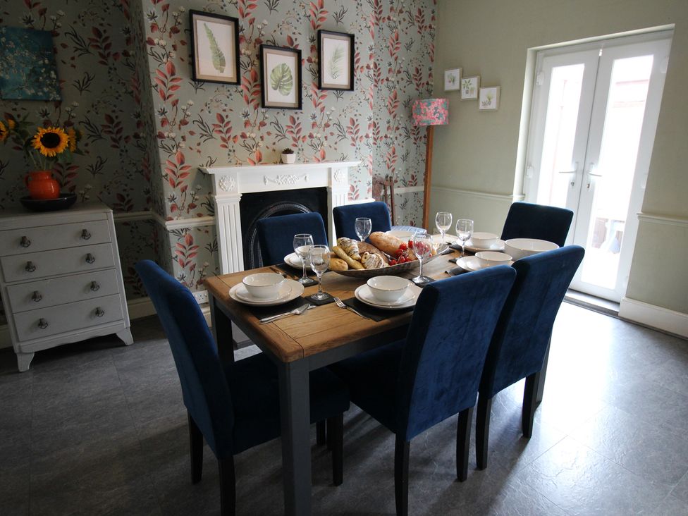 A dining room with a table set for a meal at The Hampton in Scarborough