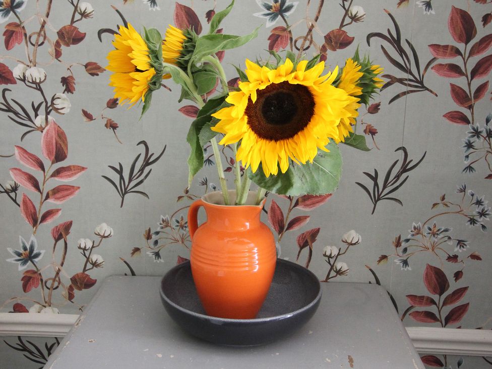 A vase with sunflowers on a table at The Hampton in Scarborough
