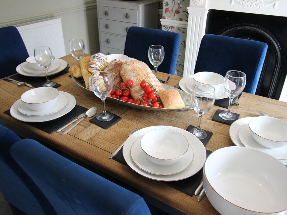 A dining room table set with bowls and bread at The Hampton in Scarborough