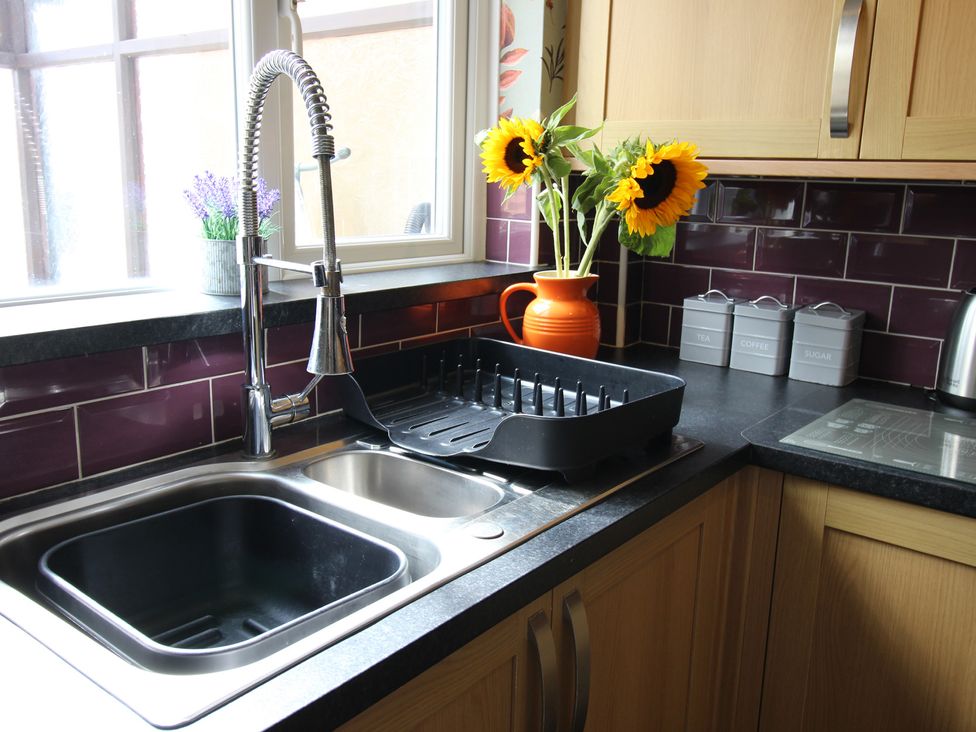 A kitchen with sink and dish rack at The Hampton in Scarborough