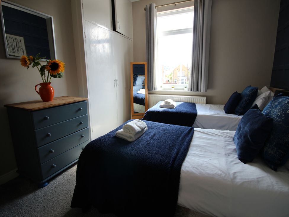A bedroom with two beds and a flower vase at The Hampton in Scarborough