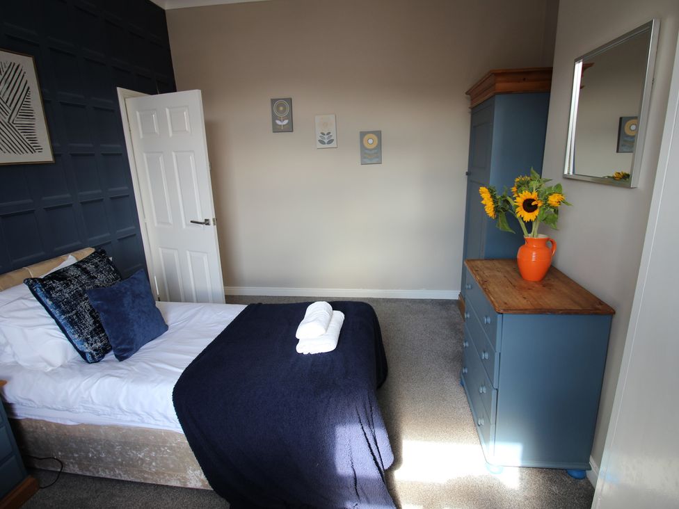 A bedroom with a bed and wardrobe at The Hampton in Scarborough