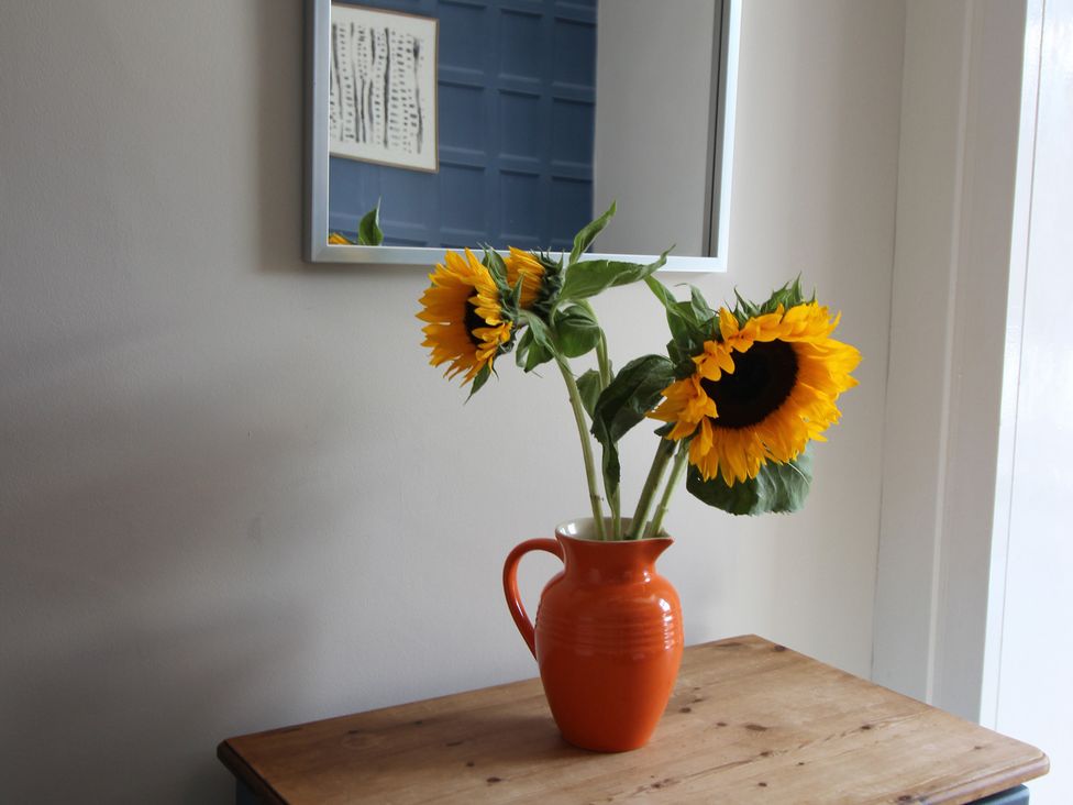 A vase with sunflowers on a table at The Hampton in Scarborough
