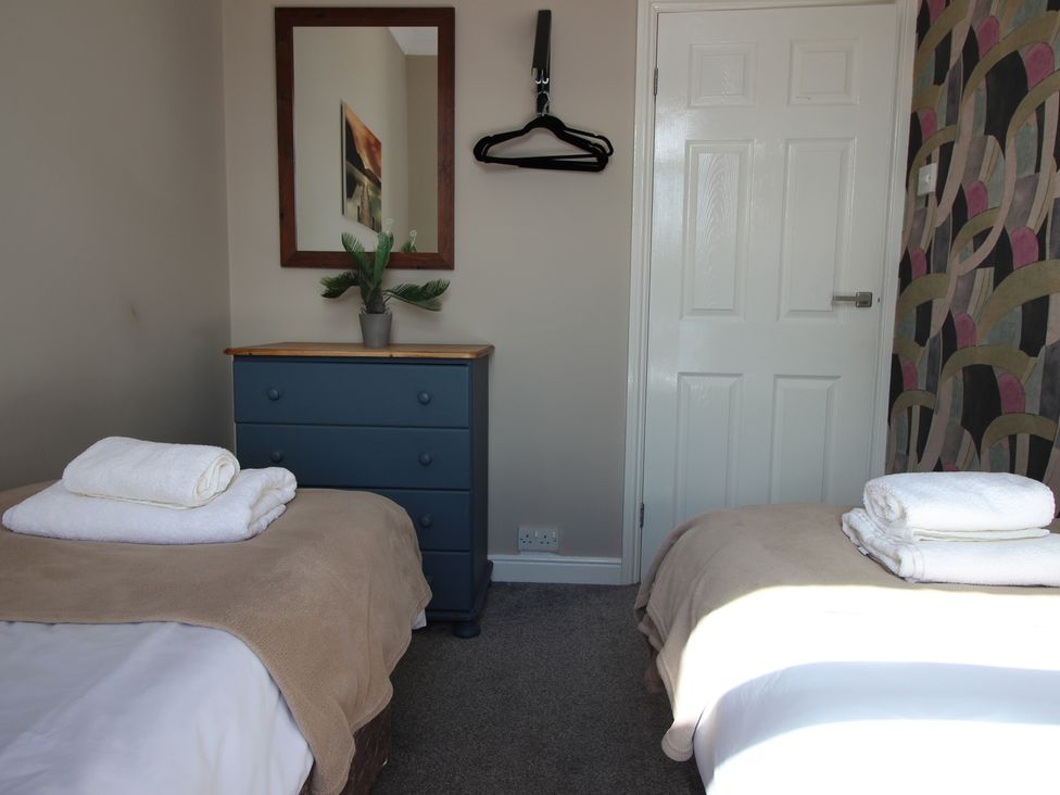 A bedroom with two beds and a dresser at The Hampton in Scarborough