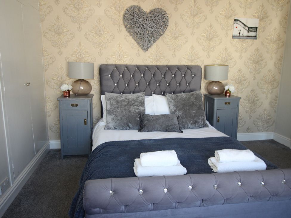 A bedroom with a bed and bedside tables at The Hampton in Scarborough