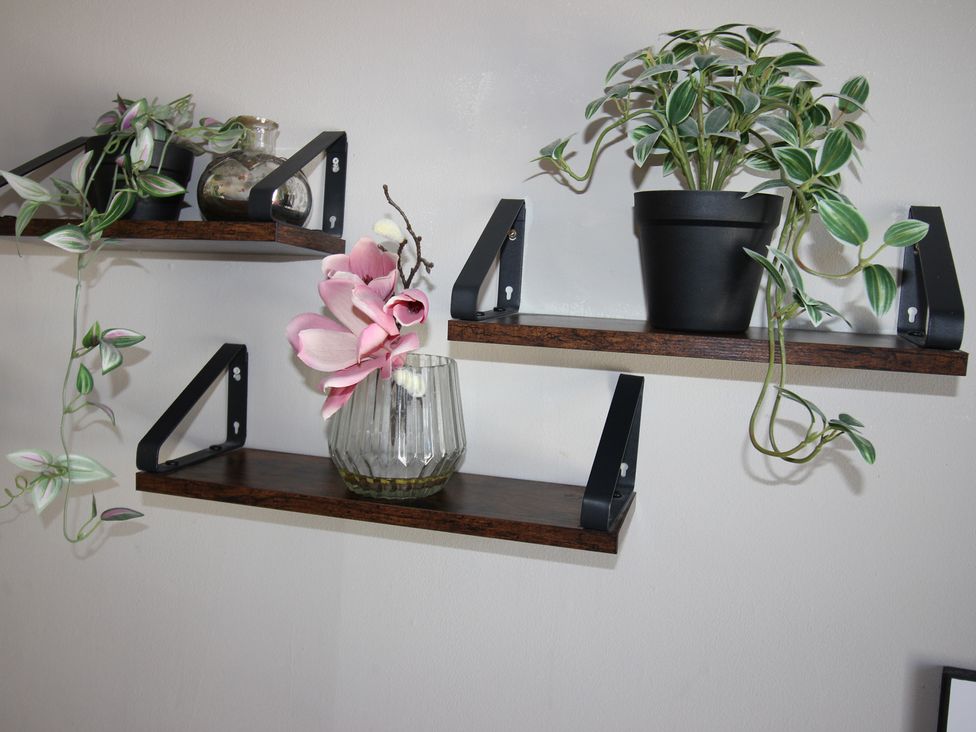 Shelves with potted plants and a glass vase at The Hampton in Scarborough