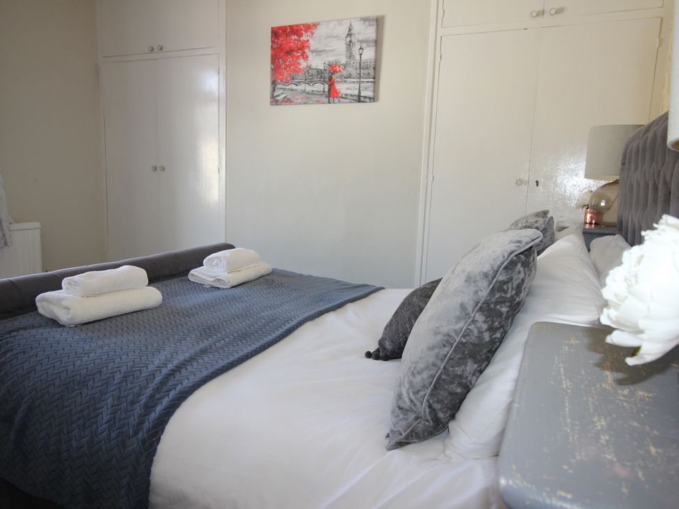 A bedroom with a bed and wardrobe at The Hampton in Scarborough