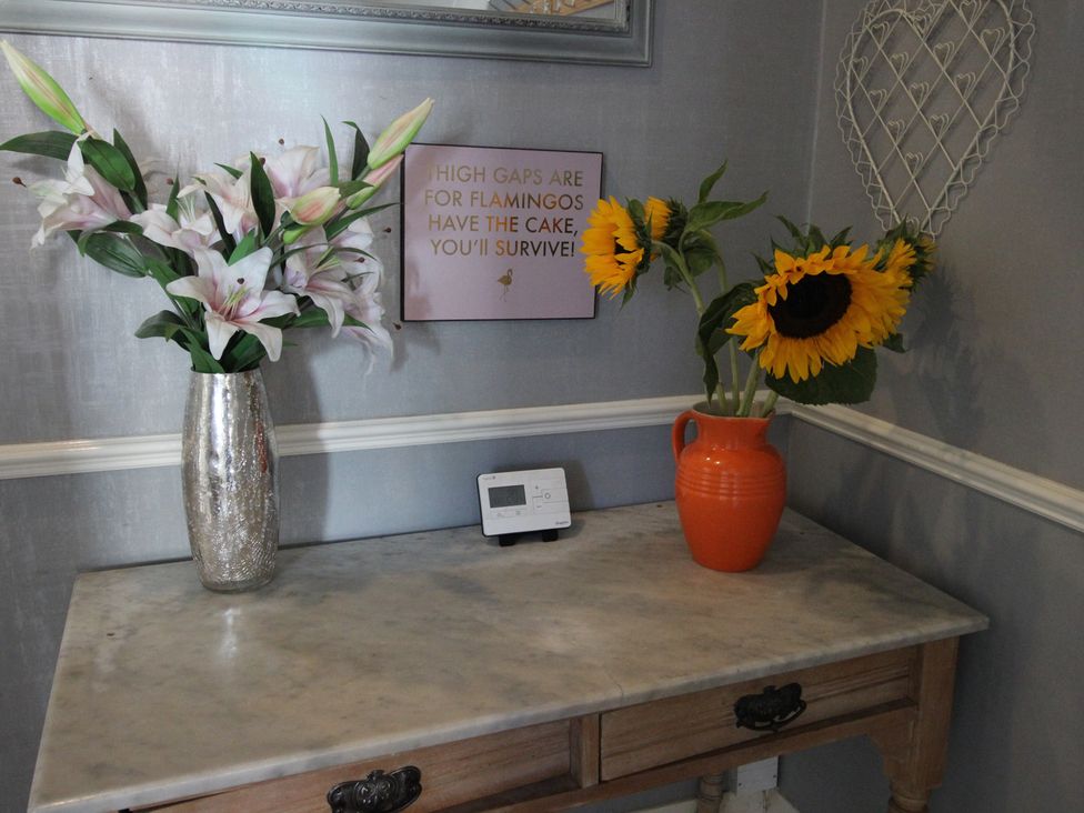 An entryway with flowers on a table at The Hampton in Scarborough