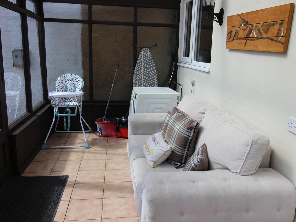 A conservatory with a sofa and a high chair at The Hampton in Scarborough