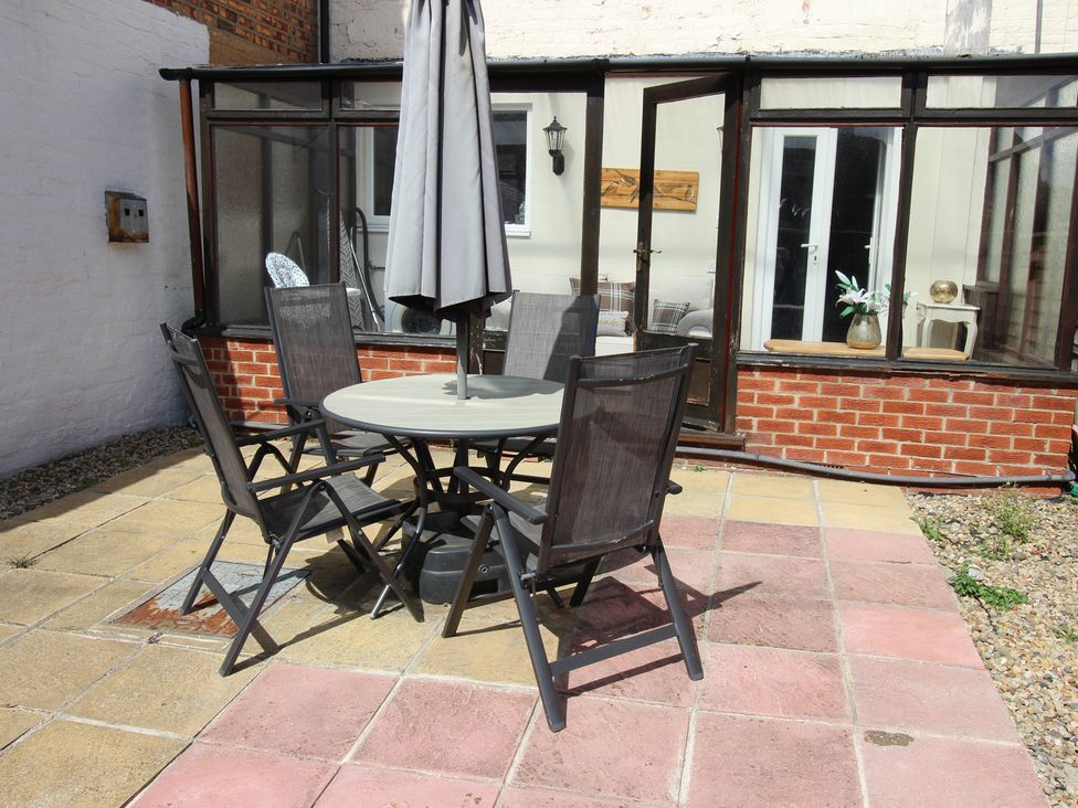 An outdoor seating area with a table and chairs at The Hampton in Scarborough