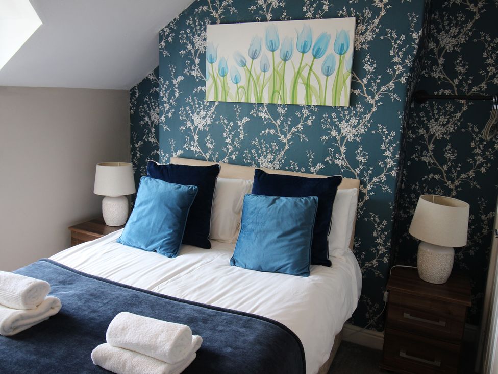 A bedroom with a bed and bedside tables at The Trafalgar in Scarborough