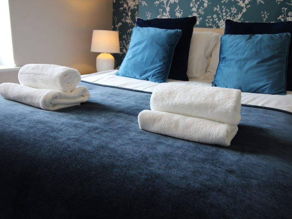 A bedroom with bed and towels at The Trafalgar in Scarborough