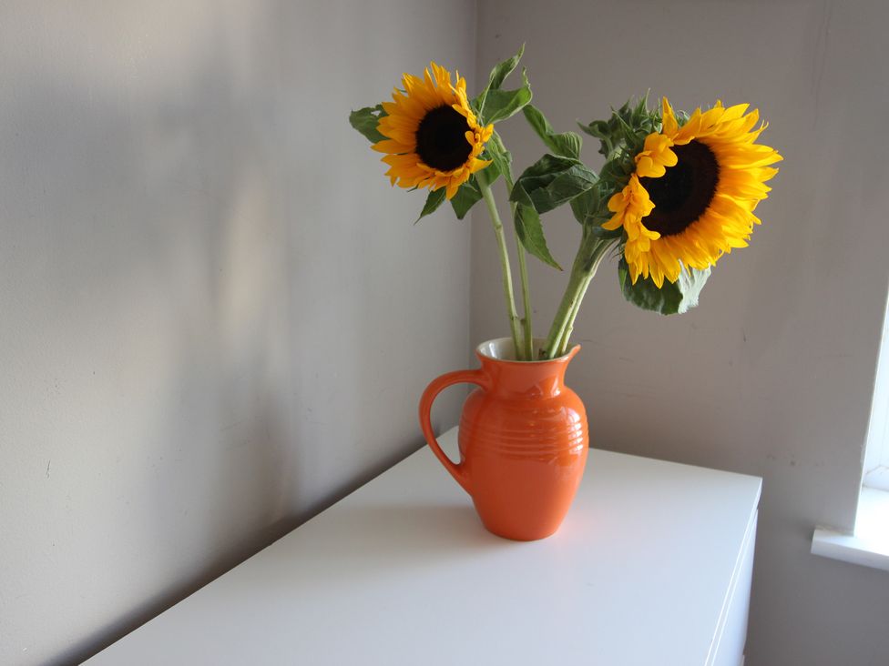 A vase with sunflowers on a table at The Trafalgar in Scarborough