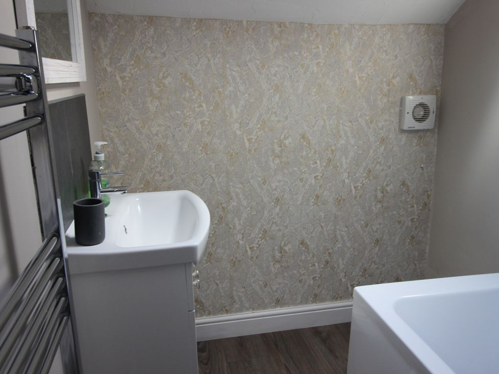 A bathroom with a sink and bath at The Trafalgar in Scarborough