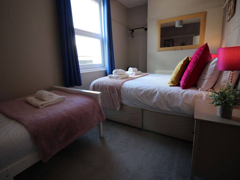 A bedroom with two beds and a nightstand at The Trafalgar in Scarborough
