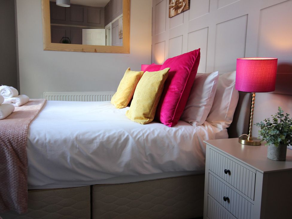 A bedroom with a bed and bedside table at The Trafalgar in Scarborough