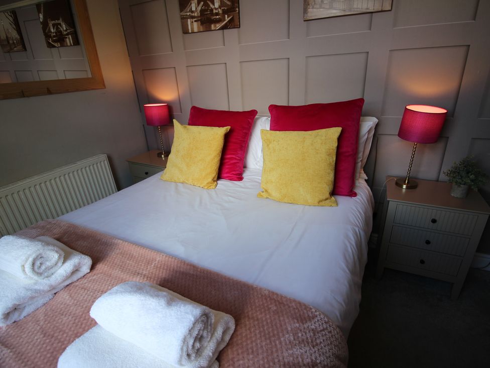 A bedroom with a bed and pillows at The Trafalgar in Scarborough