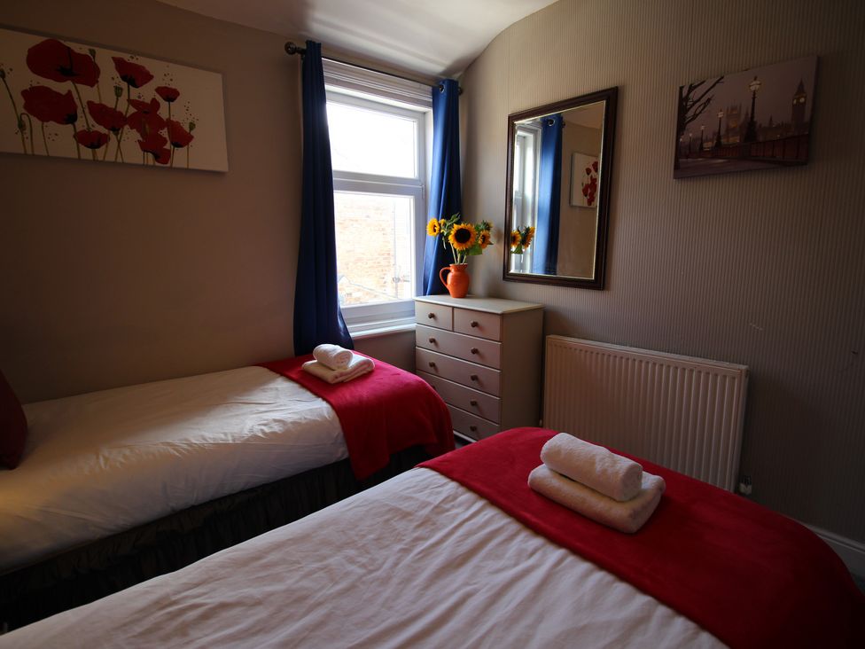 A bedroom with two beds and a window at The Trafalgar in Scarborough