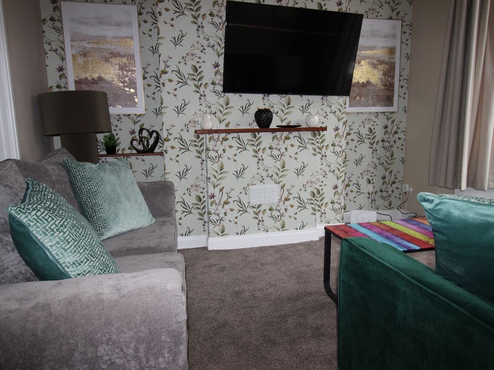 A living room with a couch and television at Brinkburn House Scarborough