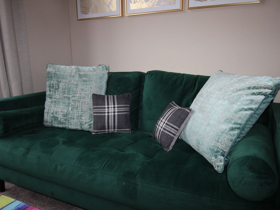 A couch with decorative pillows in a living room at Brinkburn House, Scarborough