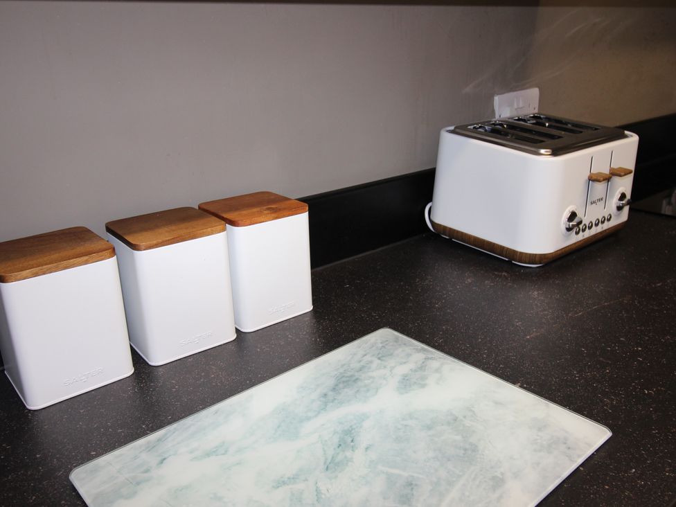 A kitchen counter with a toaster and storage containers at Brinkburn House in Scarborough