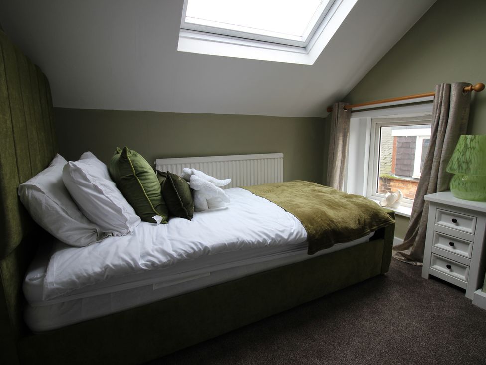 A bedroom with a bed and window at Brinkburn House in Scarborough
