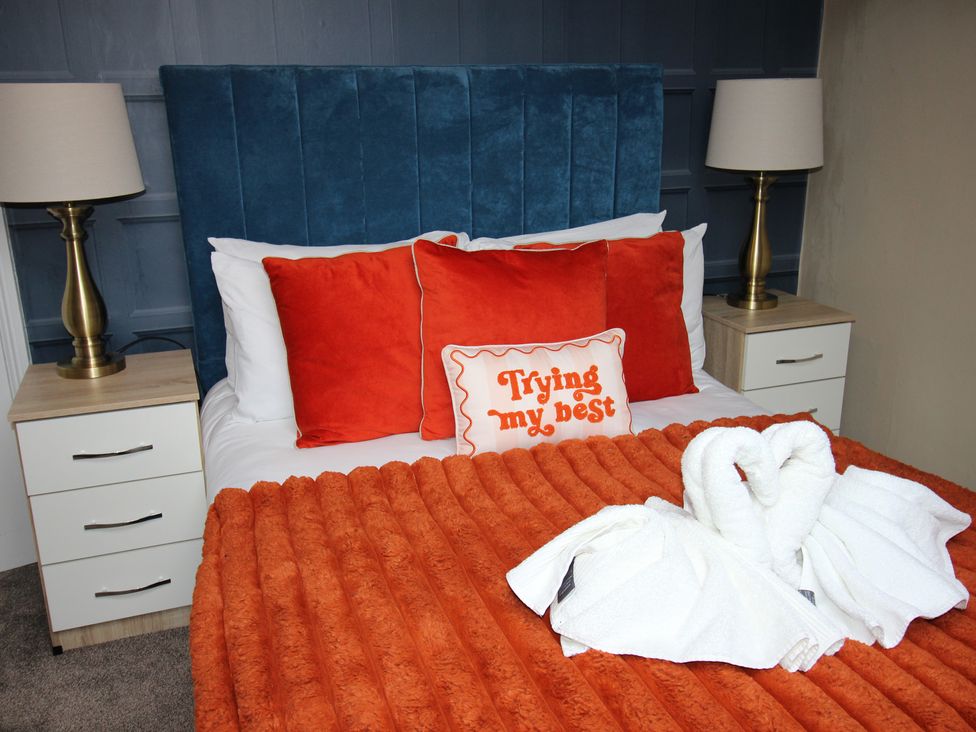 A bedroom with a bed and pillows at Brinkburn House Scarborough