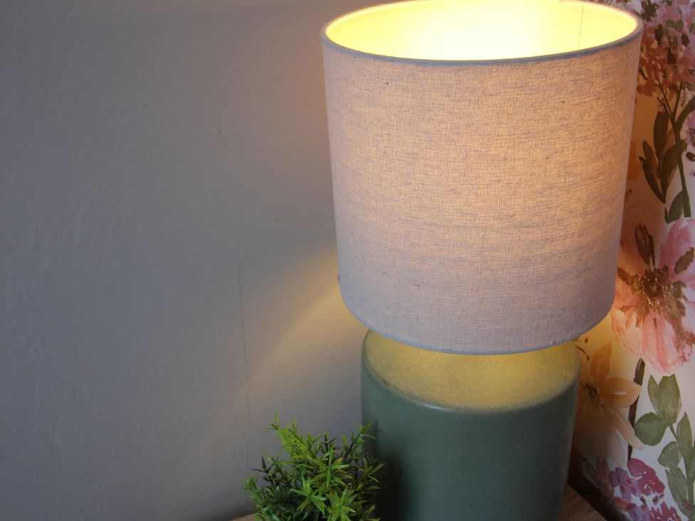 A lamp and a plant on a table at Brinkburn House in Scarborough