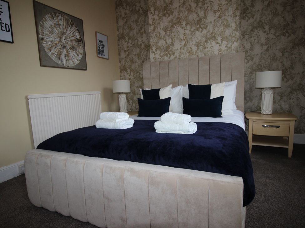 A bedroom with a bed and bedside table at Brinkburn House in Scarborough