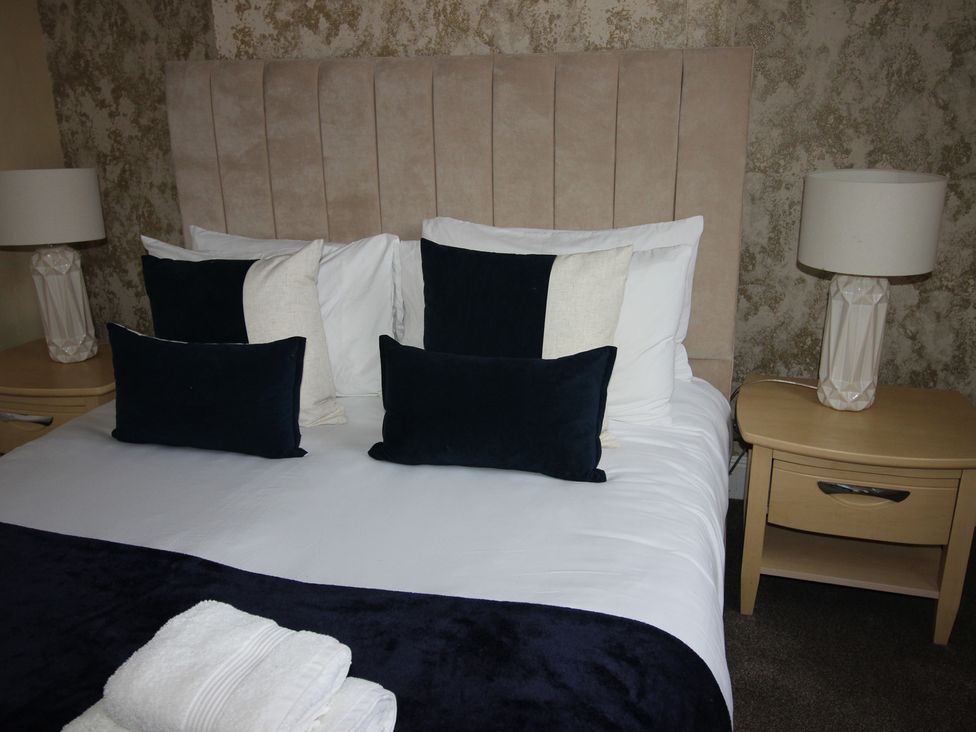 A bedroom with a bed and bedside lamps at Brinkburn House Scarborough