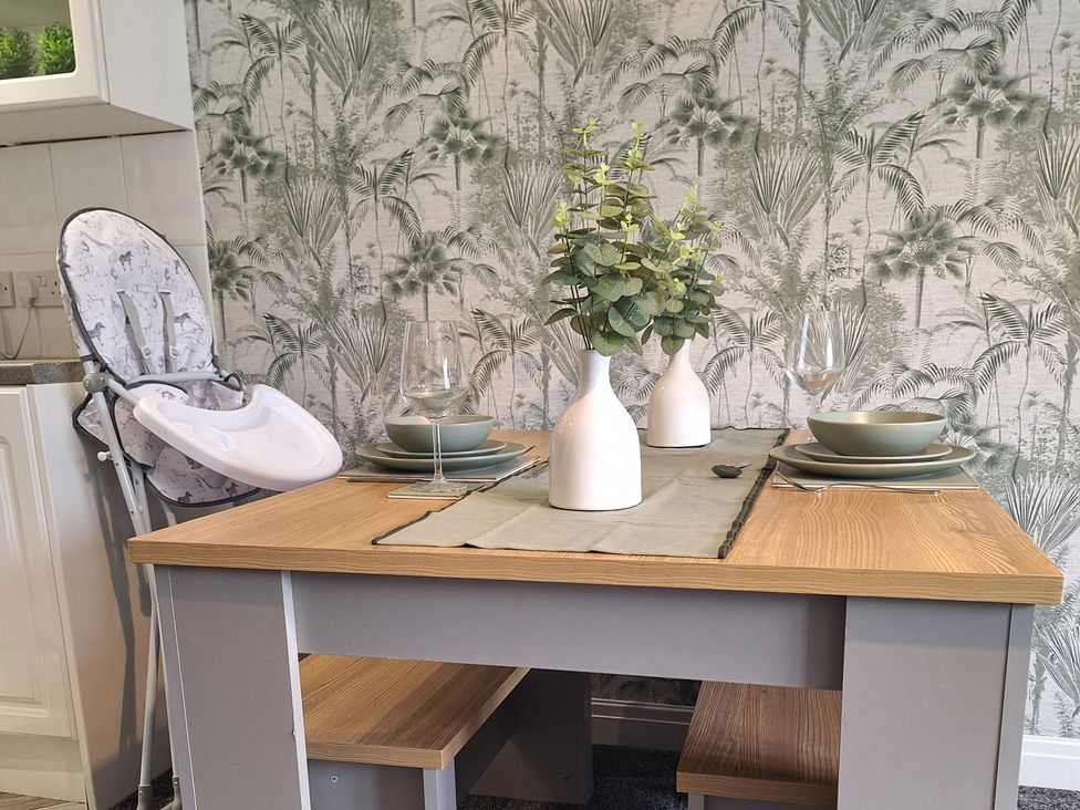 A dining area with a table set for two at Old Coach House Apartment in Scarborough