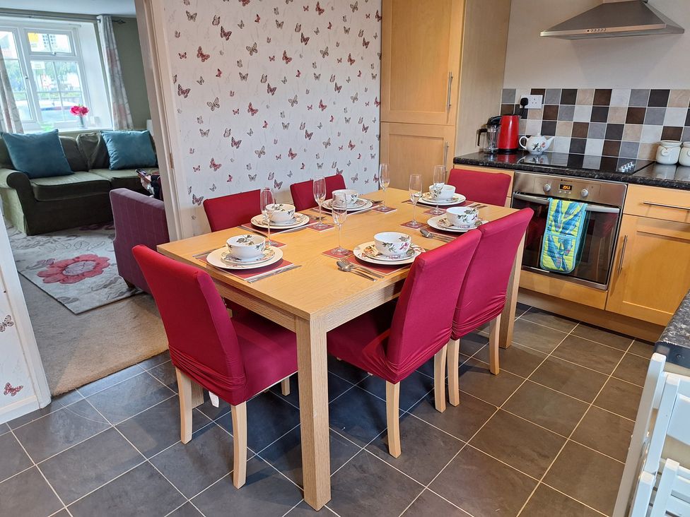 A dining room with a table set for dinner at Fryers Cottage in Seamer, North Yorkshire