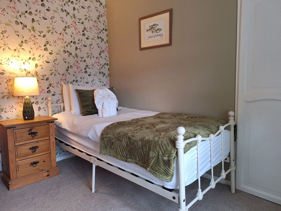 A bedroom with a single bed and nightstand at Fryers Cottage in Seamer, North Yorkshire