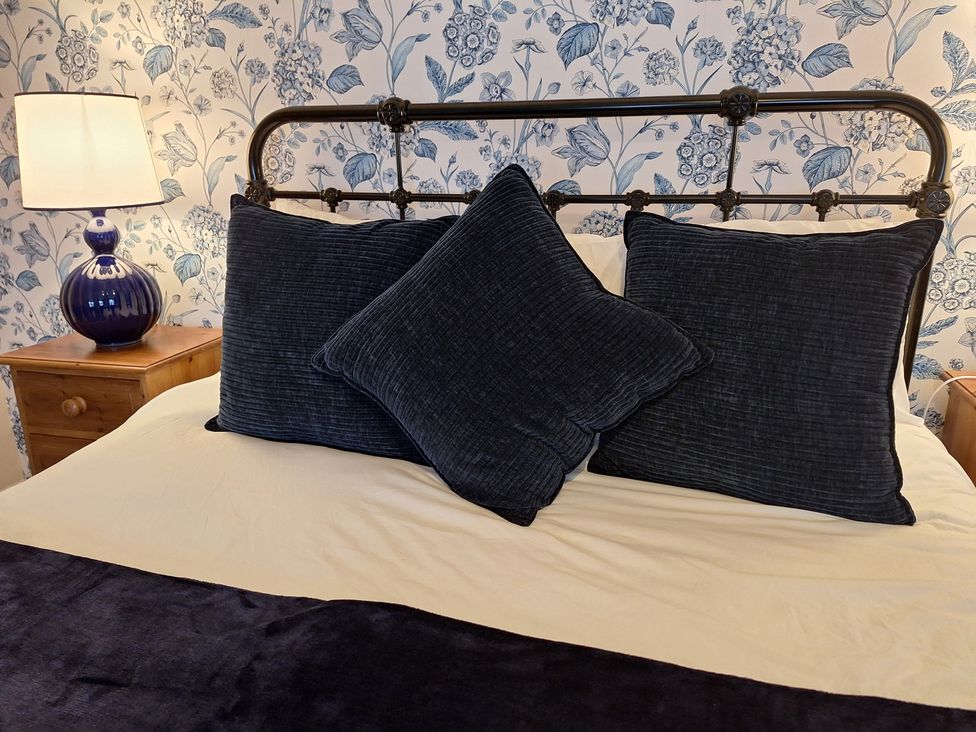 A bedroom with a bed and pillows at Fryers Cottage, Seamer, North Yorkshire
