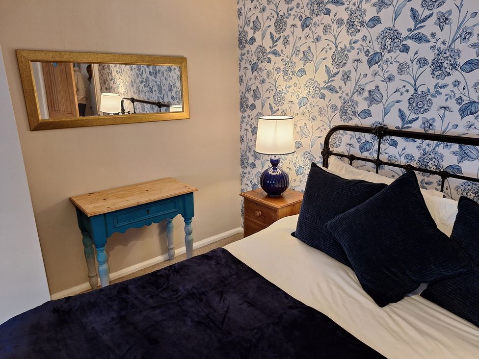 A bedroom with a bed and bedside table at Fryers Cottage in Seamer, North Yorkshire