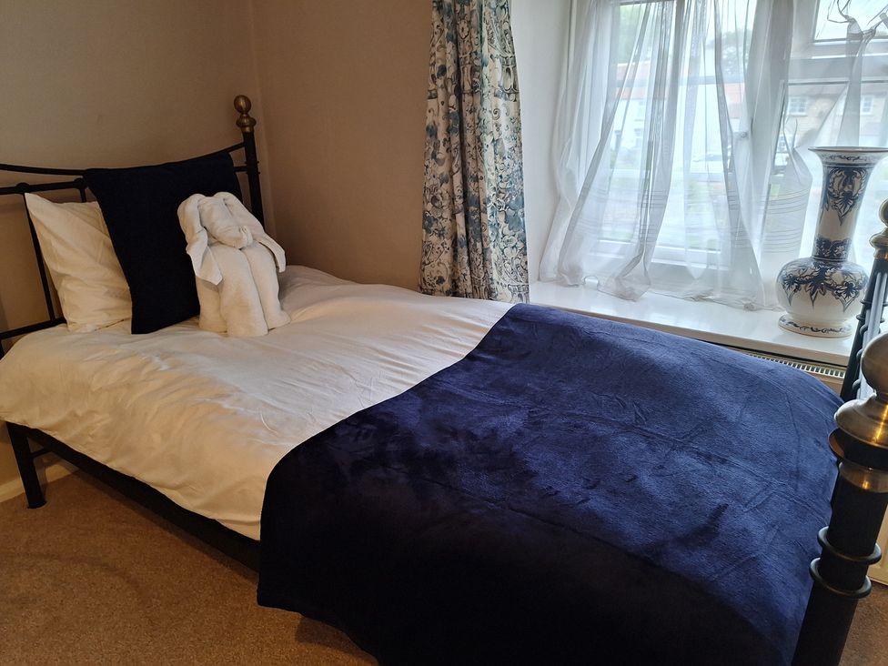 A bedroom with a bed and a window at Fryers Cottage, Seamer, North Yorkshire
