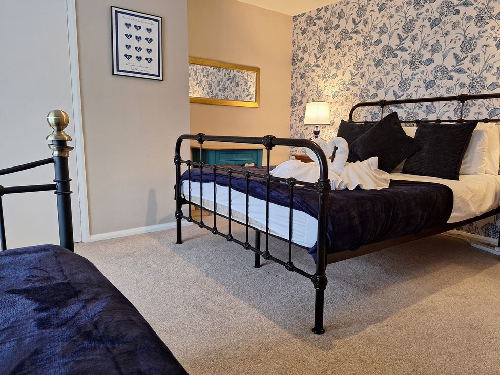 A bedroom with a bed and decorative items at Fryers Cottage in Seamer, North Yorkshire